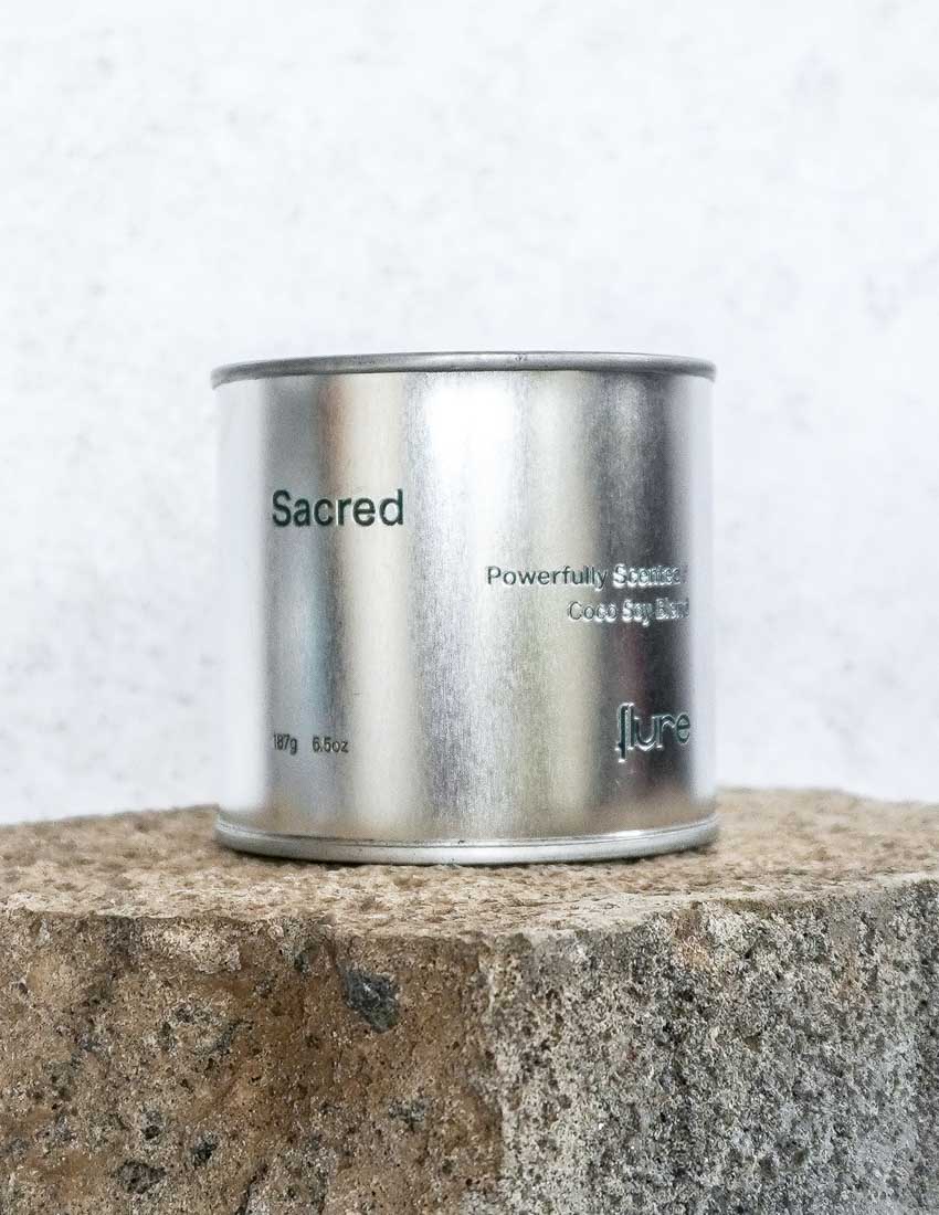 Large size silver travel tin candle of fragrance scent sacred close up.