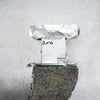 Hand blown candle of fragrance scent spot on - close up of silver packaging.