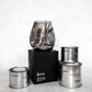 Group photo of the pure hand blown candle with tin collection scents in image.