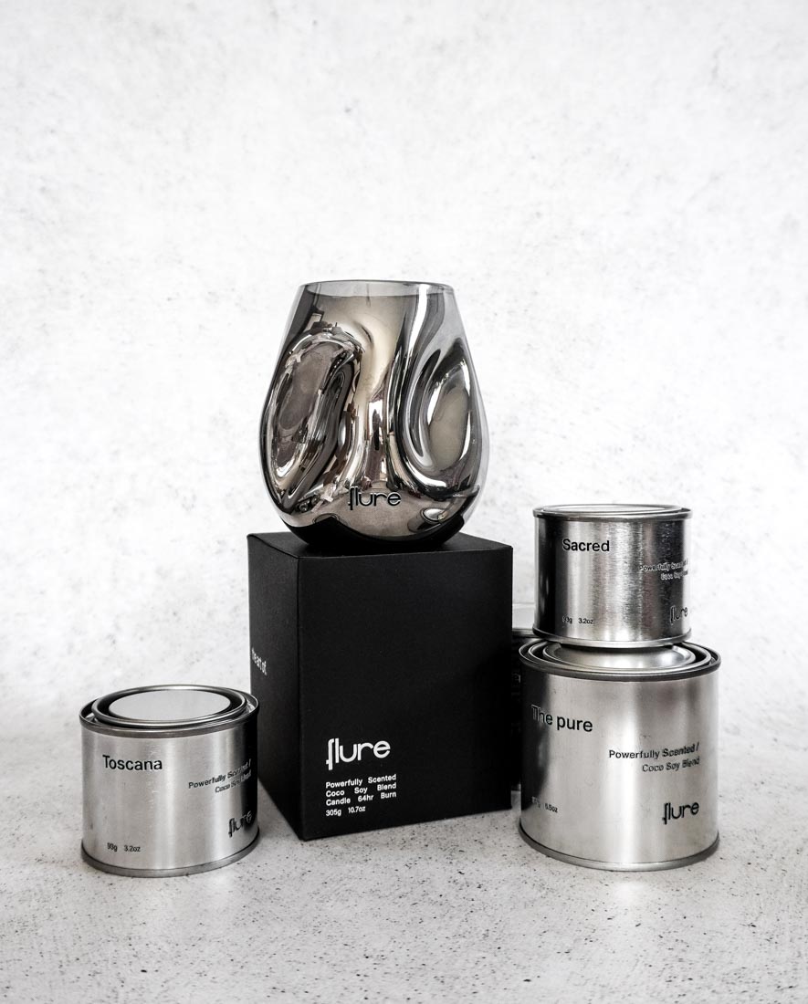 Group photo of the pure hand blown candle with tin collection scents in image.