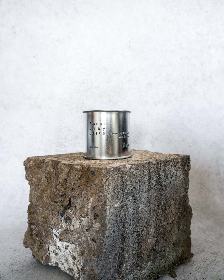 Large sized silver travel tin candle of fragrance scent  sweet baby jesus - wide shot.