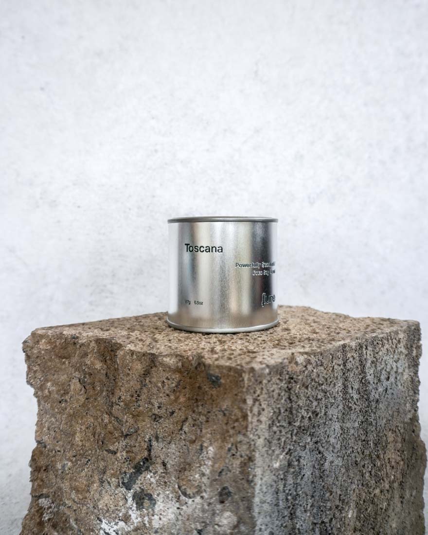 Large sized silver travel tin candle of the fragrance scent toscana - wide shot.