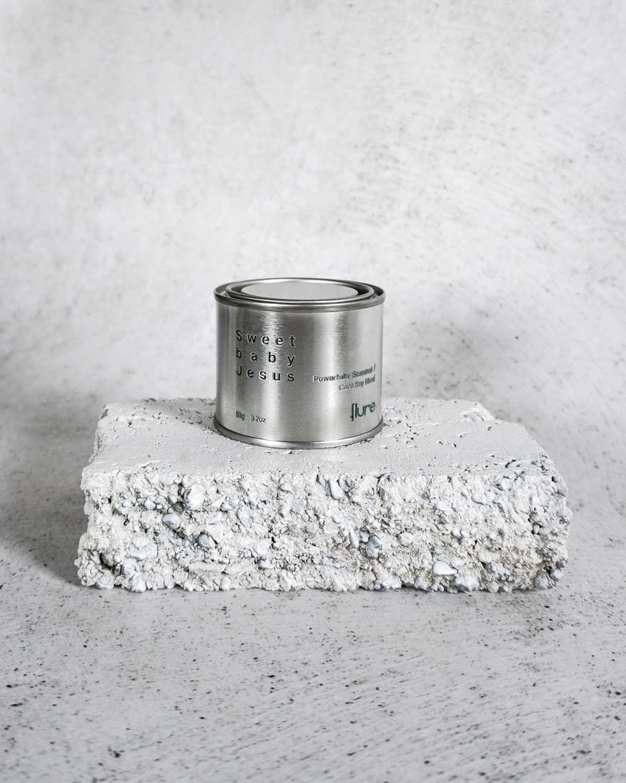 Medium sized silver travel tin candle of fragrance scent sweet baby jesus - wide shot.