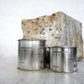 Group image of flure's travel tin collection in fragrance scent understated beauti in medium and large size - close up.