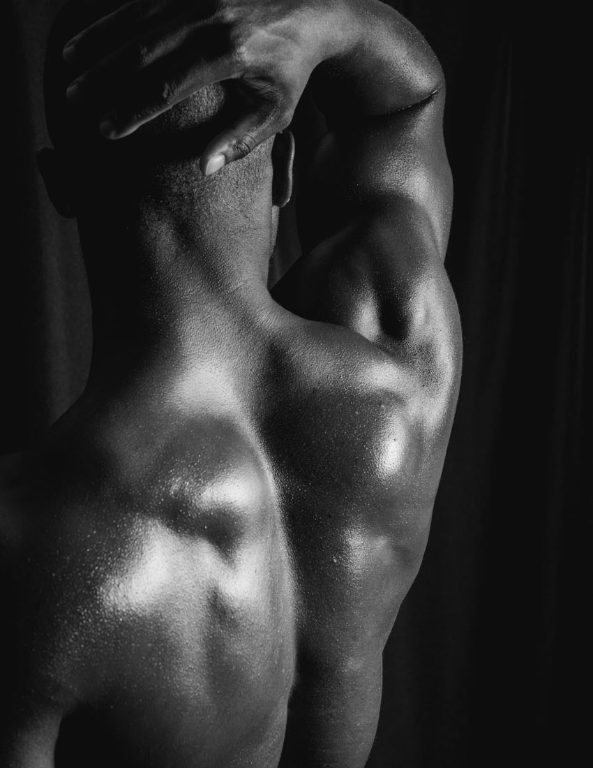 Candle scent image for the fragrance figure. Picture of a black male models back to depict the masculine sexy scent.