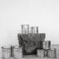 Group image of flure's travel tin collection in different scents and sizes.