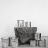 Group image of flure's travel tin collection in different scents and sizes.