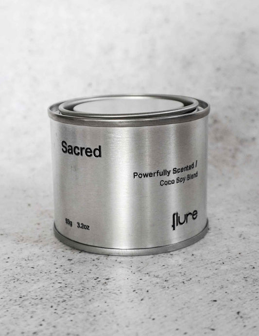 Medium sized silver travel tin candle of fragrance scent sacred - close up