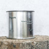 Large sized silver travel tin candle of scent figure front shot