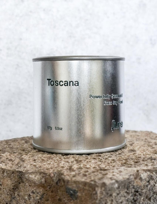 Large sized silver travel tin candle of the fragrance scent toscana - close up.