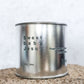 Large sized silver travel tin candle of fragrance scent  sweet baby jesus - close up detail shot.