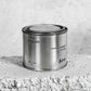 Medium sized silver travel tin candle of scent figure close up.