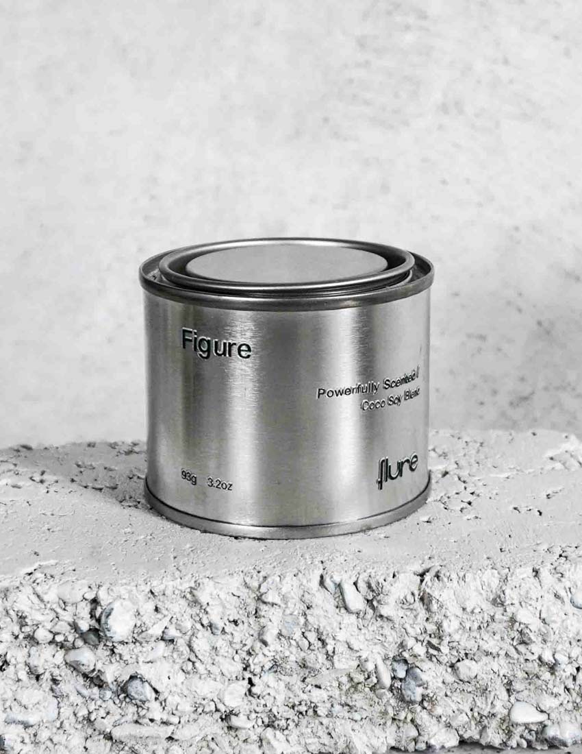 Medium sized silver travel tin candle of scent figure close up.
