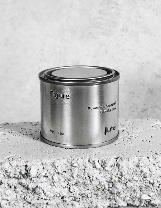 Medium sized silver travel tin candle of scent figure close up.