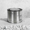 Medium sized silver travel tin candle of scent figure close up.