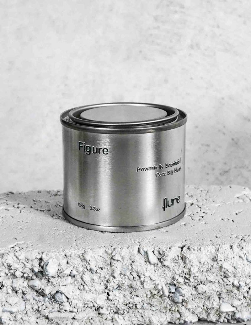 Medium sized silver travel tin candle of scent figure close up.