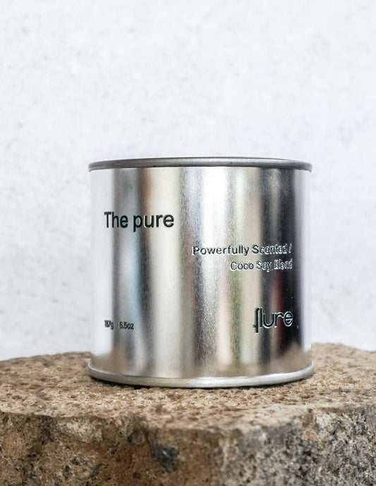 Large sized silver travel tin candle of fragrance scent the pure - close up shot.