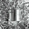 Medium sized silver travel tin candle of fragrance scent the pure - metallic background wide shot.