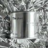 Medium sized silver travel tin candle of fragrance scent the pure - close up on metallic background.