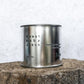 Large sized silver travel tin candle of fragrance scent  sweet baby jesus - close up image.