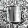 Large sized silver travel tin candle of scent figure on metallic background.
