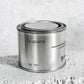 Medium sized silver travel tin candle of fragrance scent toscana - close up.