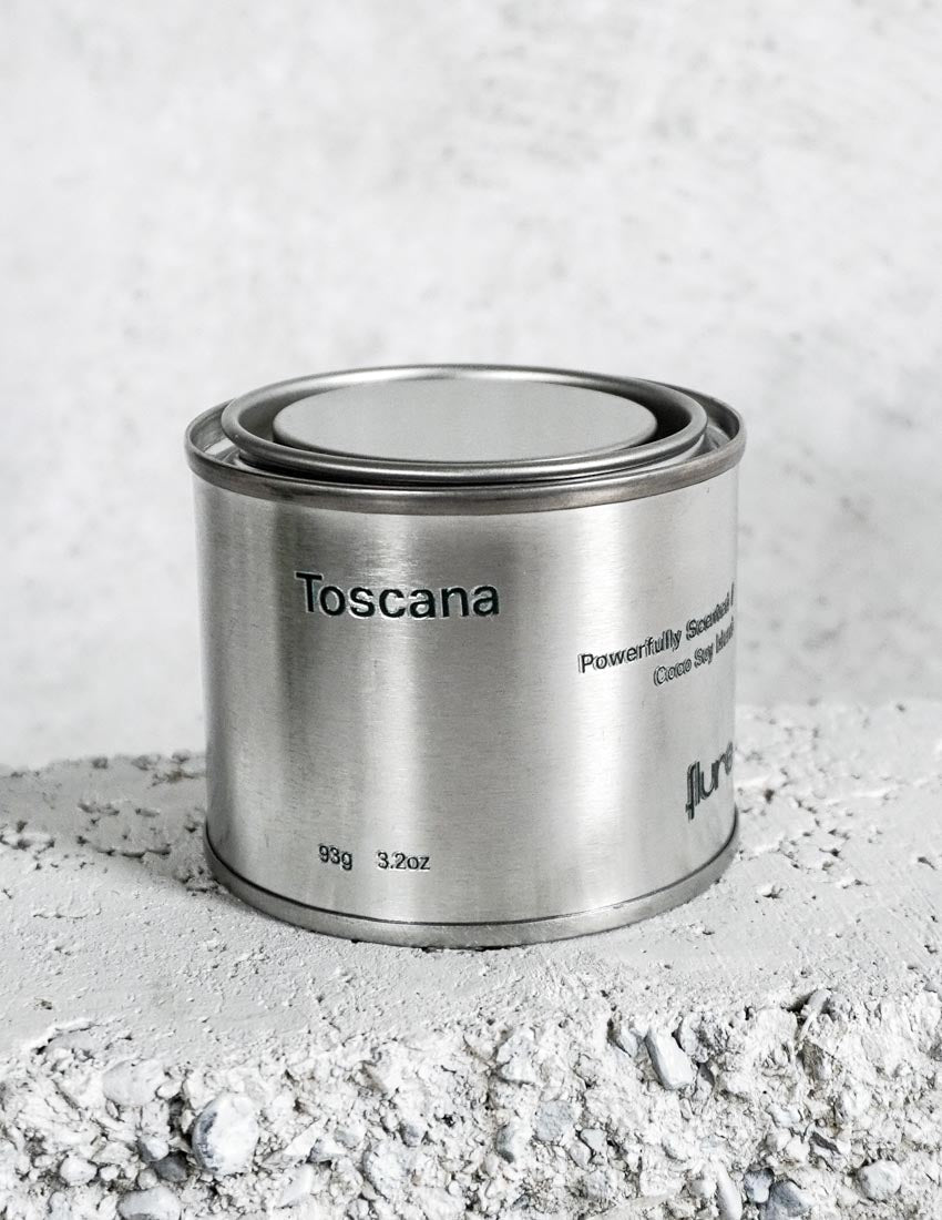 Medium sized silver travel tin candle of fragrance scent toscana - close up.