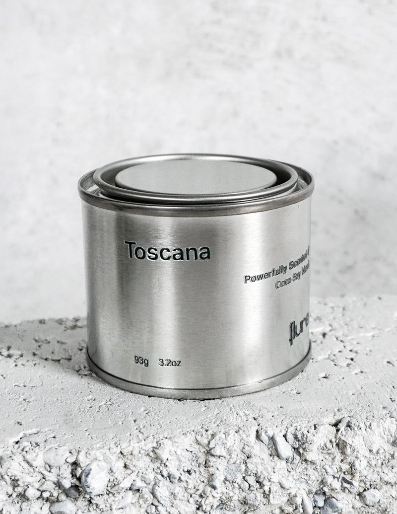 Medium sized silver travel tin candle of fragrance scent toscana - close up.
