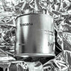 Large sized silver travel tin candle of the fragrance scent toscana - close up on metallic background.