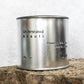 Silver travel tin candle of fragrance scent understated beauti - close up shot.