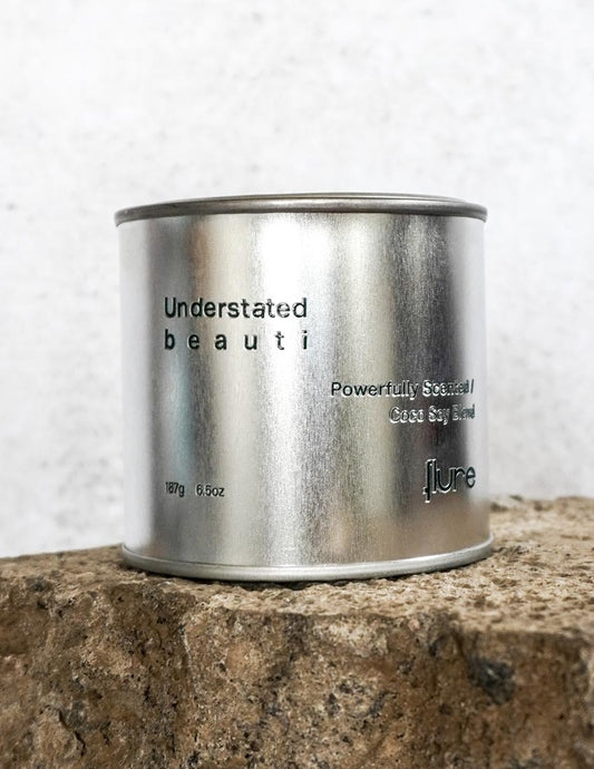 Silver travel tin candle of fragrance scent understated beauti - close up shot.